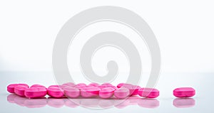 Pile of pink tablets pill isolated on white background. Norfloxacin 400 mg for treatment cystitis. Antibiotics drug resistance.