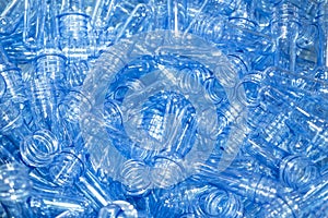 The pile of preform shape  PET bottles in the container box.