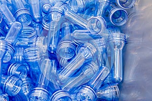 The pile of preform shape of plastic bottles from the injection process.