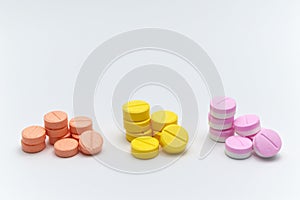 Pile of prescription drugs, pills and tablets of different colors, Orange Yellow and pink