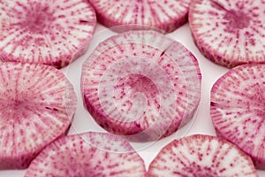 Pile of purple daikon radish slice isolated on white background