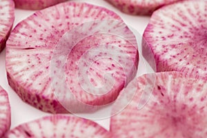 Pile of purple daikon radish slice isolated on white background