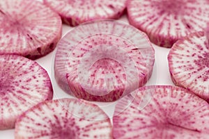 Pile of purple daikon radish slice isolated on white background