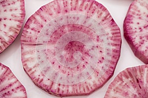 Pile of purple daikon radish slice isolated on white background