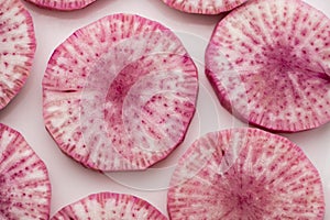 Pile of purple daikon radish slice isolated on white background