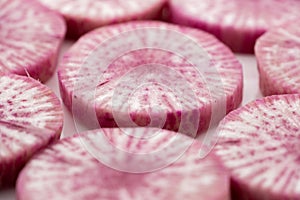 Pile of purple daikon radish slice isolated on white background