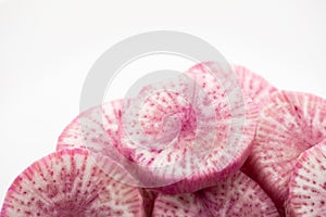 Pile of purple daikon radish slice isolated on white background