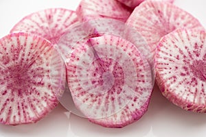 Pile of purple daikon radish slice isolated on white background