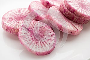 Pile of purple daikon radish slice isolated on white background