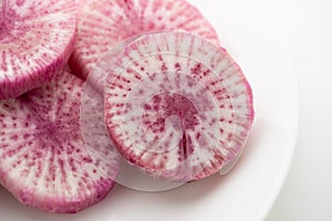 Pile of purple daikon radish slice isolated on white background