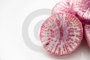 Pile of purple daikon radish slice isolated on white background