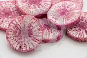 Pile of purple daikon radish slice isolated on white background