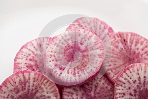 Pile of purple daikon radish slice isolated on white background