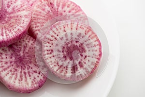 Pile of purple daikon radish slice isolated on white background