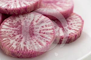 Pile of purple daikon radish slice isolated on white background