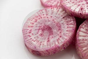 Pile of purple daikon radish slice isolated on white background