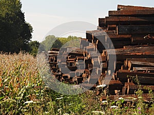 Pile of railway sleepers next to Cornfield