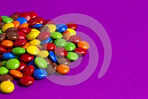 Pile of Rainbow Colored Candy Coated Chocolate Buttons