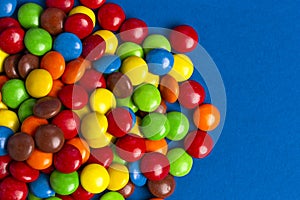 Pile of Rainbow Colored Candy Coated Chocolate Buttons