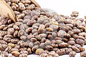 pile of Rajado beans, brazilian beans, with wooden measuring spoon, copy space, macro photography photo