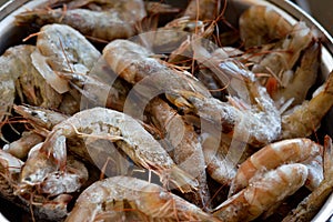 Pile of raw frozen shrimps, a crustacean (a form of shellfish) with an elongated body