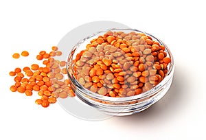 A pile of raw red lentils in a glass container, isolated on a white background. useful product