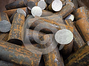 a pile of raw steel short rods cutted by saw- workpieces prepaired for forging, close-up with selective focus
