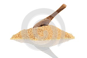 Pile of raw sugar with wood spoon