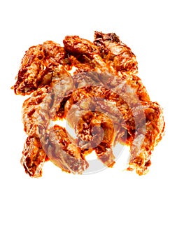 Pile of raw uncooked marinated chicken wings on white background. High quality poultry product with delicate rich flavor. Food