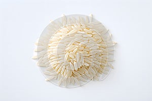 A pile of raw white rice on a white background. Top view.Close up of long rice grains can use for background and texture.