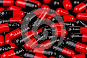 Pile of red-black capsule pills. Antibiotics resistance. Drug use with reasonable. Global healthcare concept. Antibiotics drug res