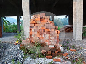 A pile of red bricks used to build a house or building.