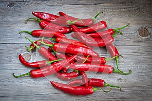 Pile of red chili peppers on wooden background