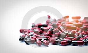 Pile of red and grey capsule pills isolated on white background with copy space. Flunarizine : drug for migraine prophylaxis