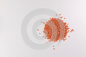 Pile red lentils on white background