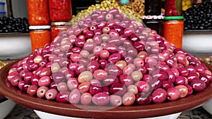 Pile of red Moroccan olives in the souk, Medina, in Marrakech Marrakesh, Morocco.