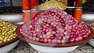 Pile of red Moroccan olives in the souk, Medina, in Marrakech Marrakesh, Morocco.