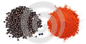 Pile of red paprika powder and Black pepper seeds on white background photo