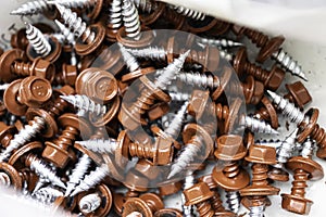 Pile of red roofing screws in a hardware store