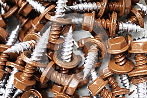 Pile of red roofing screws in a hardware store