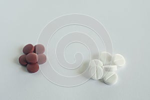 Pile of red and white pills on blue background with copy space. medicine concept