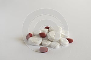 Pile of red and white pills on blue background with copy space. medicine concept