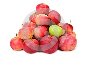 A pile of red and yellow apples. Among them is one green apple. Isolated on white background