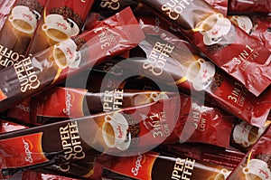 A pile of regular flavoured super instant coffee beverage sachets