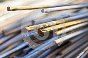 Pile of reinforcing steel bars as an abstract industrial background. Photo with selective focus