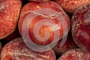 a pile of ripe washed peaches on the table