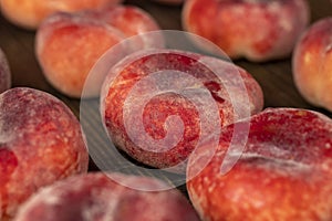 a pile of ripe washed peaches on the table