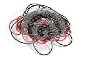 Pile of Rolled Red and Black Electric Extension Cables