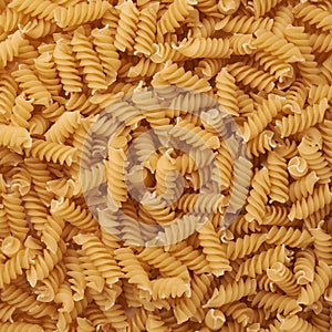 Pile of rotini yellow pasta as abstract background