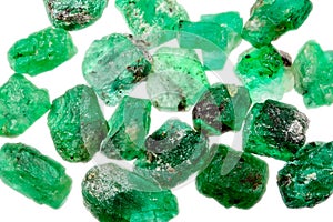 A pile of rough uncut green emeralds